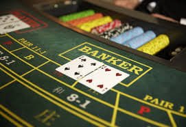 Tampilan meja BandarQ dengan posisi taruhan pemain dan bandar Close-up dari meja BandarQ dengan dealer dan area taruhan chip
